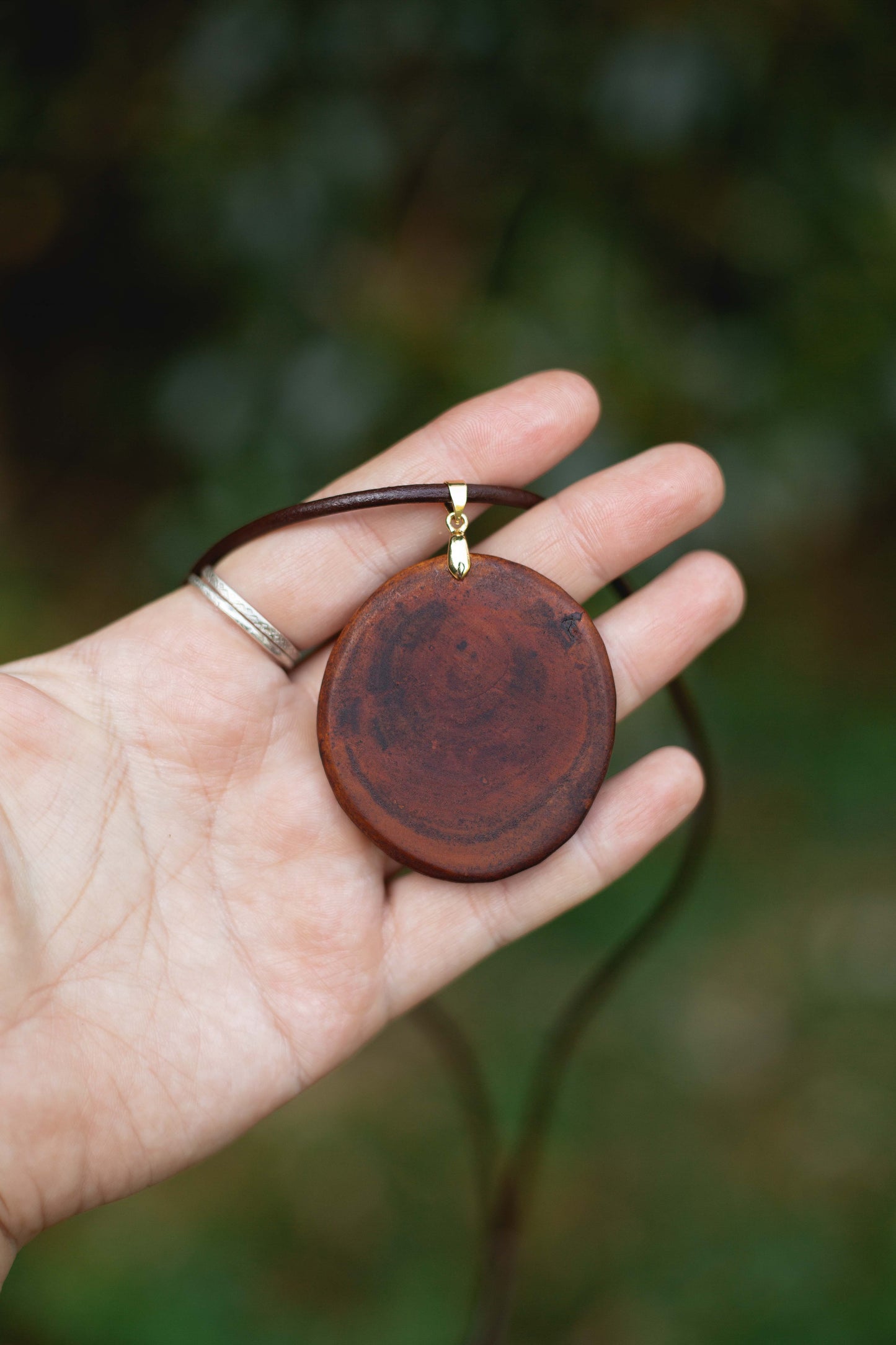 Hand-carved eucalyptus slice pendant on gold-plated bail