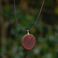 Hand-carved eucalyptus slice pendant on gold-plated bail