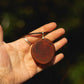 Hand-carved eucalyptus slice pendant on gold-plated bail