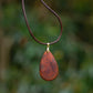 Hand-carved eucalyptus tear drop slice pendant on gold-plated bail